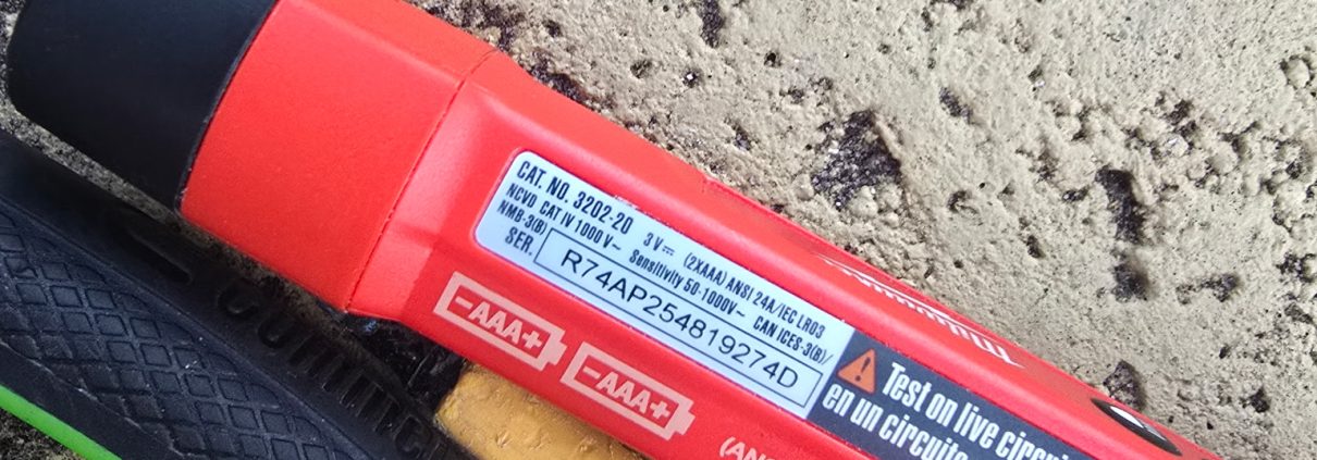 Close-up of a voltage tester, hammer and pliers used by an H3 Industries handyman in Palm Beach Gardens