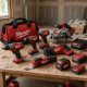 Milwaukee cordless power tools and tool bag laid out on a workbench by an experienced H3 Industries handyman in Palm Beach Gardens
