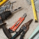 Drywall tools and metal framing materials, including a drill, tin snips, tape measure and level, for plasterboard wall work by H3 Industries in Palm Beach Gardens